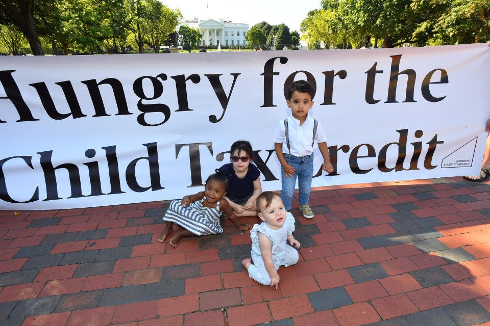 Parents and caregivers with the Economic Security Project gather outside the White House to advocate for the Child Tax Credit in advance of the White House Conference in Washington, DC. (Credit: Larry French, Getty Images)