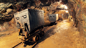 Mining cart in a silver, copper, and gold mine representing VOXR Stock.