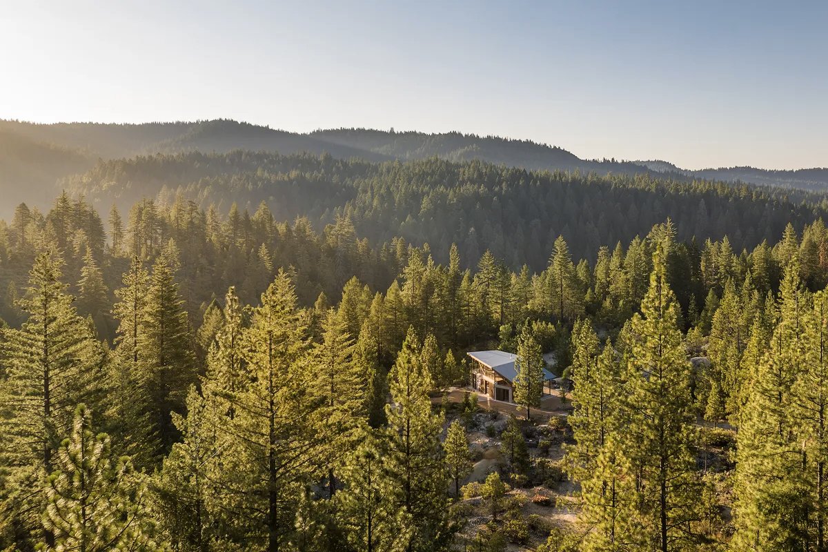 The mountain house is enveloped by 50 private acres of forest