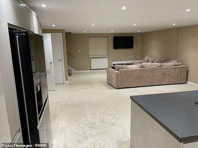 The sitting room and kitchen in Lexi's converted garage fit with marble flooring