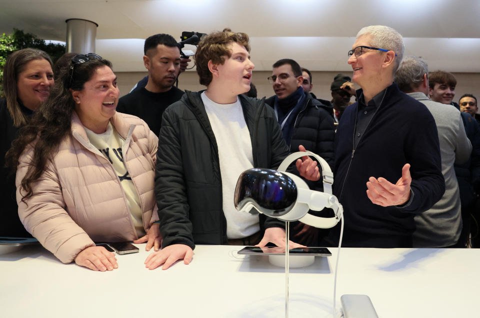 Apple CEO Tim Cook talks with customers as Apple's Vision Pro headset is displayed at the Apple Fifth Avenue store in Manhattan in New York City, U.S., February 2, 2024. REUTERS/Brendan McDermid