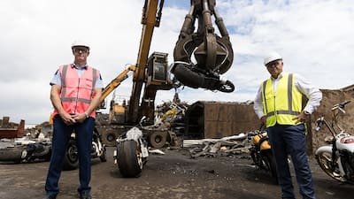Police Commissioner Andrew Coster and police minister Mark Mitchell watch as the bikes are destroyed. 