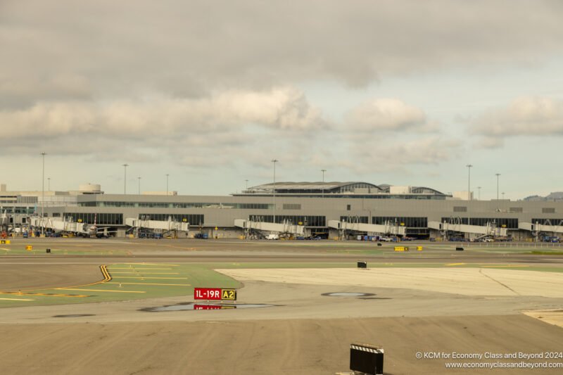 a large airport with a runway and a building