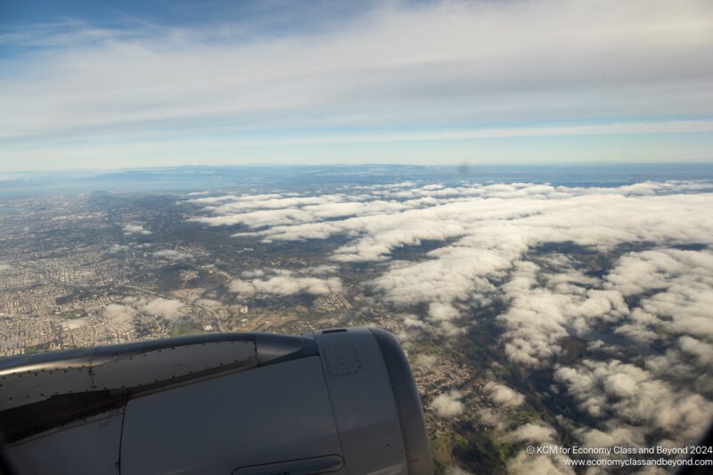 an airplane wing and the sky above clouds