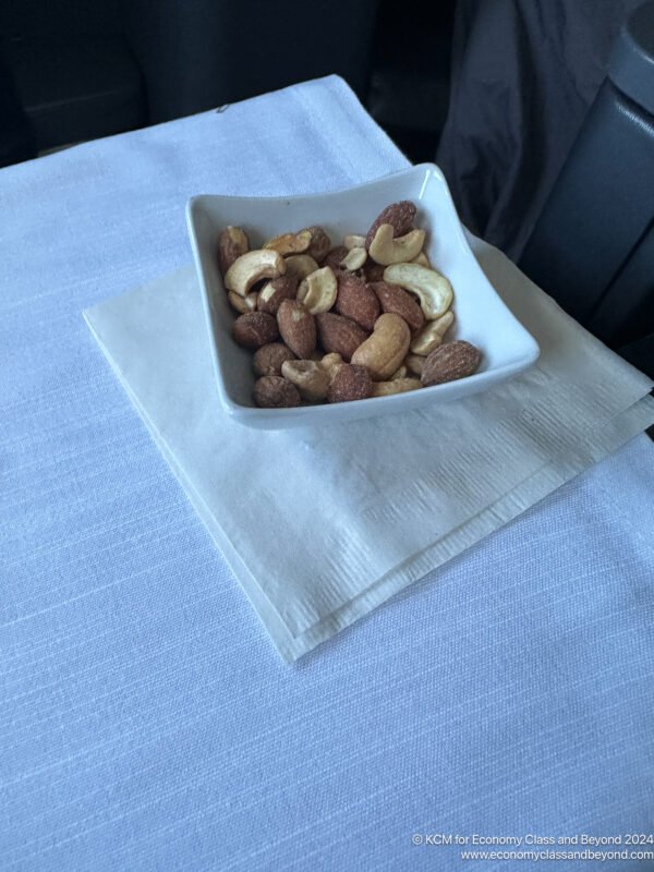 a bowl of nuts on a napkin