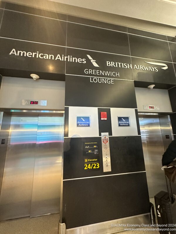 a elevator with signs and a person standing in front of them