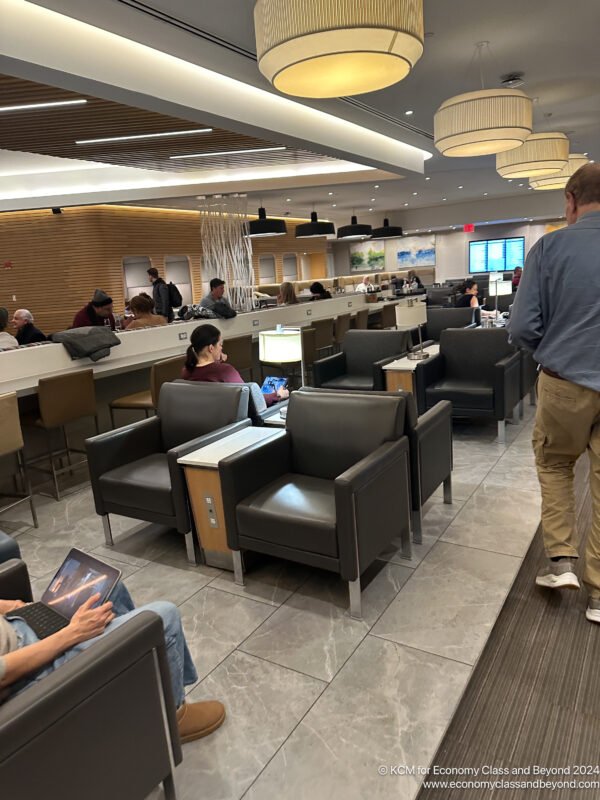 a group of people in a room with chairs and tables