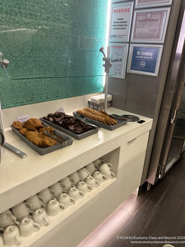 a trays of cookies and coffee cups on a counter