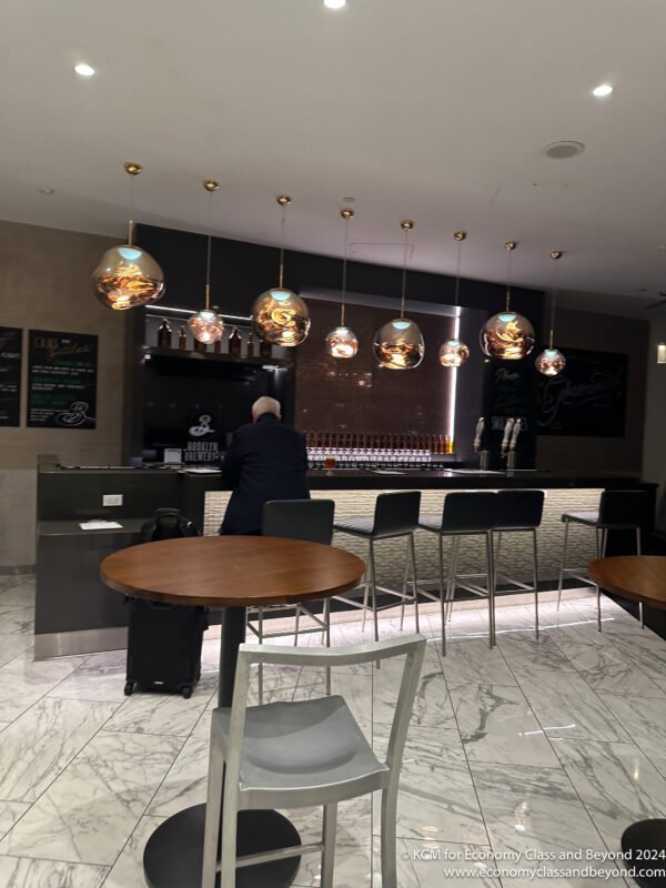 a man standing at a counter in a bar