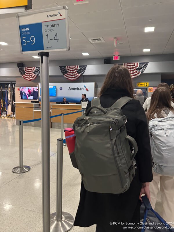 a woman with a backpack in an airport