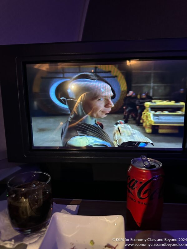 a tv screen with a drink and a can