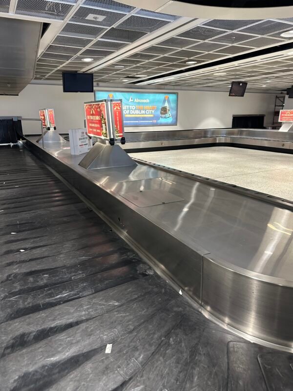 a baggage claim area with a conveyor belt