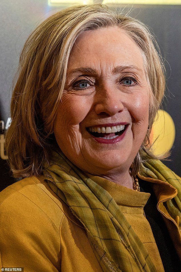 She added a pastel yellow, plaid scarf and also a few gold-chained necklaces for a flashy flare. To further accessorize her outfit, Clinton added small earrings as well as chunky bracelets on her left wrist