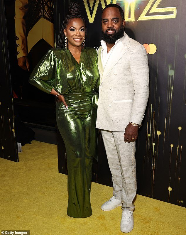 Kandi Burruss wowed in a shiny, green jumpsuit as well as a pair of dangly, gold earrings and was joined by husband, Todd Tucker