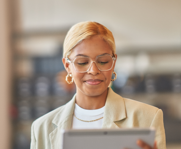 A decorative image of a finance worker viewing a tablet