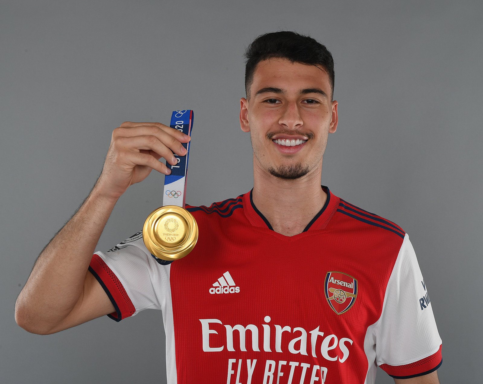 Arsenal forward Gabriel Martinelli shows off the gold medal he won with Brazil at the 2020 Olympics.