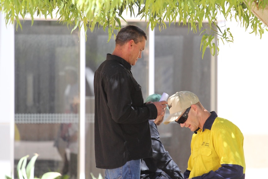 Two men outside a court house.  