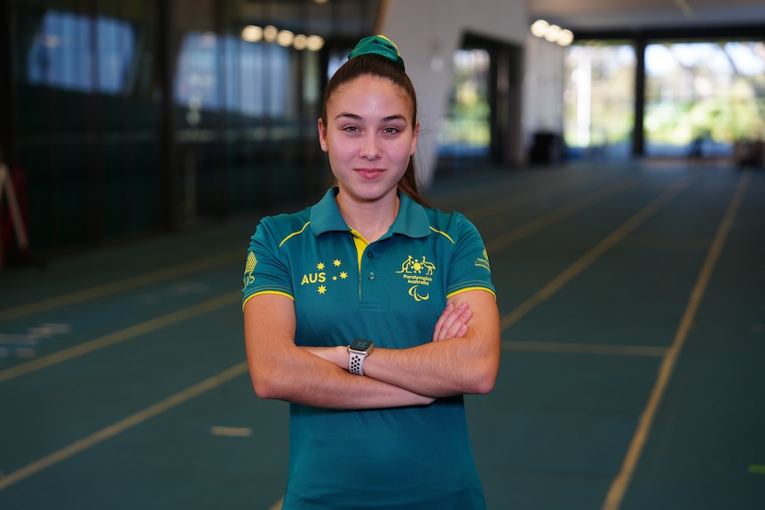 Rhiannon Clarke, WAIS athlete and paralympian, poses in the WAIS indoor running track