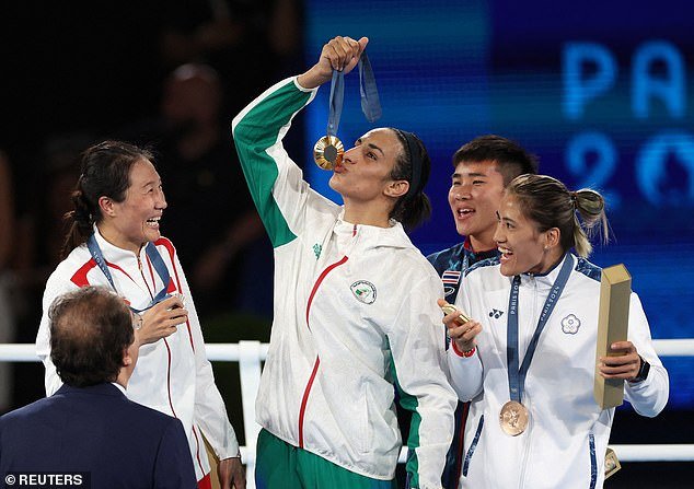 Imane Khelif of Algeria kisses her medal as silver medalist Liu Yang of China shares a laugh