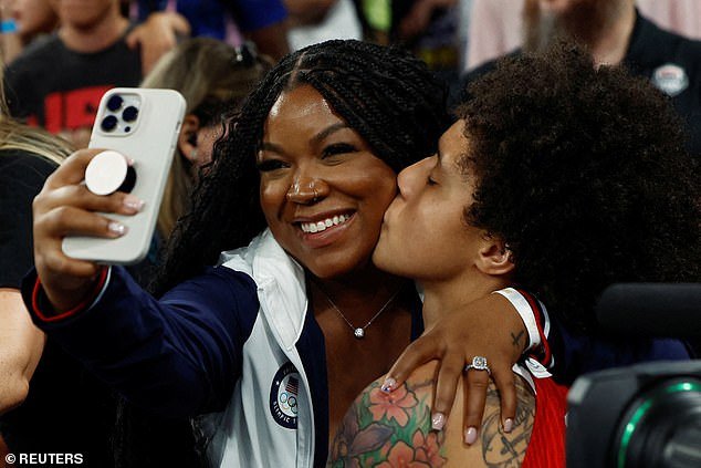 Brittney Griner of United States kisses wife Cherelle after winning the gold medal game