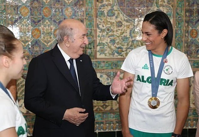 Olympic champion boxer Imane Khelif showed off her dramatic feminine makeover as she was given a significant honour by Algerian president Abdelmadjid Tebboune