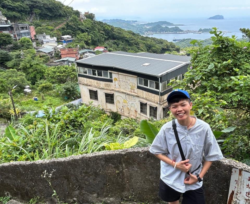 Jiufen resident Mickey Tseng standing in front of her home, which also houses a gold ore museum.