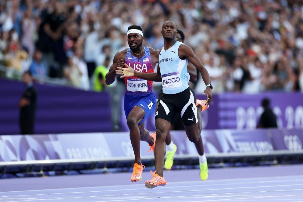 Tebogo thumps his chest as he crosses the line, in a shock win for Botswana