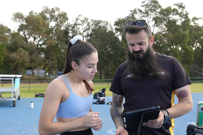 Rhiannon Clarke, WAIS athlete and paralympian, poses in the WAIS indoor running track