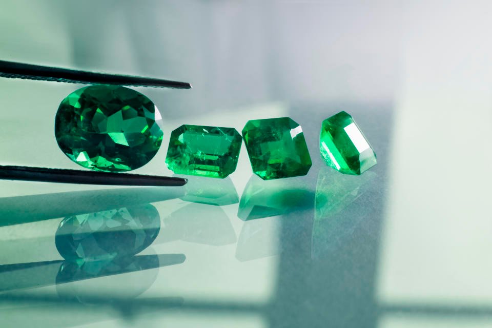 raw stones and emeralds cut