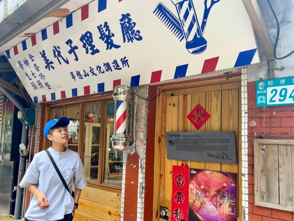 Resident Mickey Tseng in front of Miyoko Barber shop in Jiufen, Taiwan.