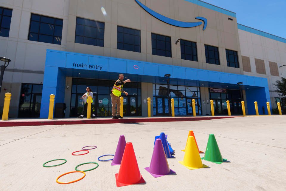 Amazon employees play during their lunch break outdoors at Amazon OXR1 fulfillment center in Oxnard, Calif., on Wednesday, Aug. 21, 2024. (AP Photo/Damian Dovarganes)