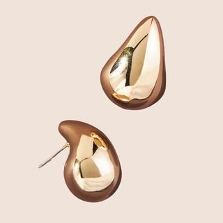 Flat lay image of gold earrings