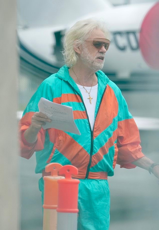 That's right, it's Bob Geldof! He looked worlds away from his normal look as he cut a vibrant figure in a bright orange and blue shell suit as he channelled 90s fashion